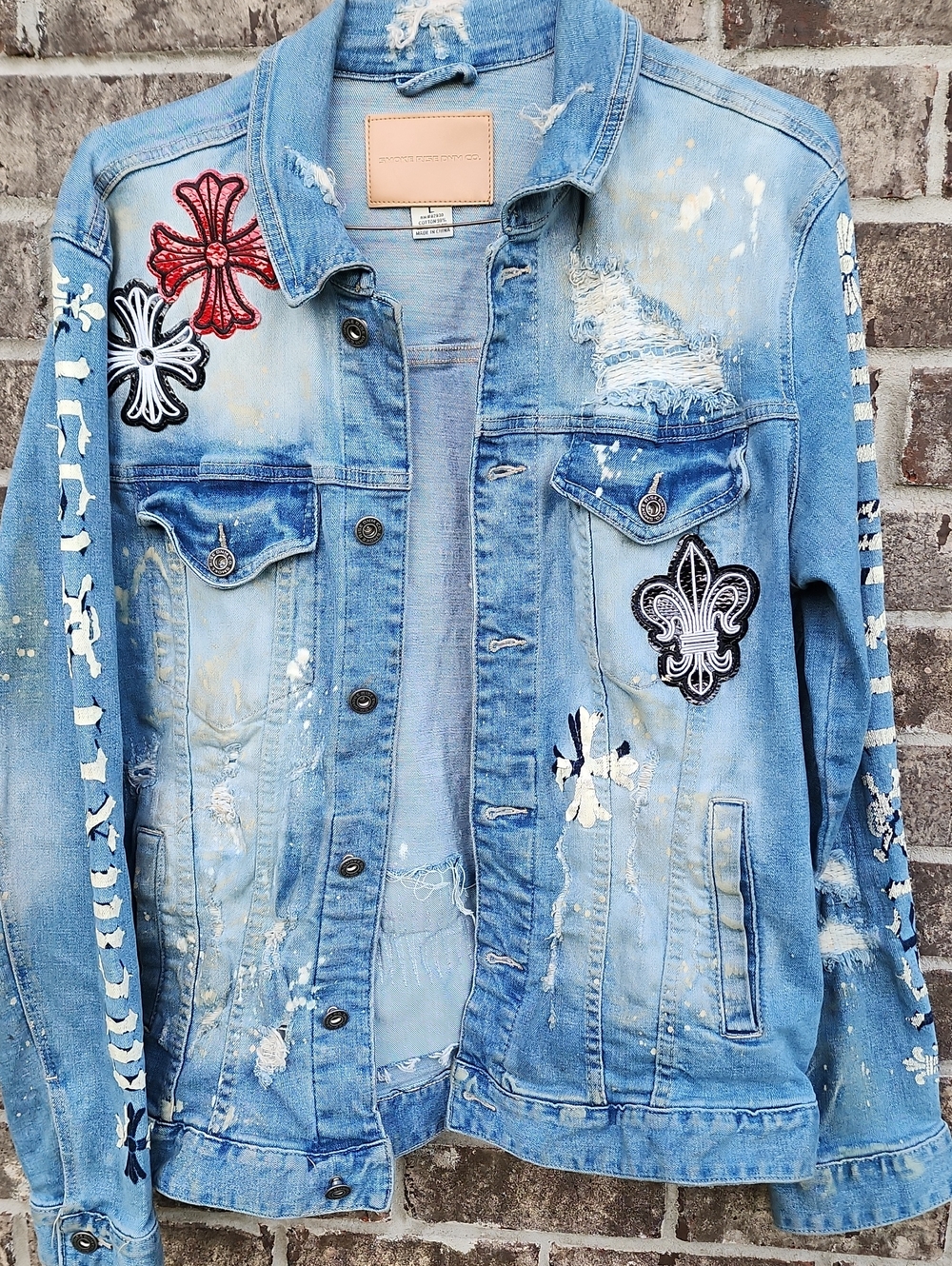 Distressed Denim Jacket with Embroidered Patches